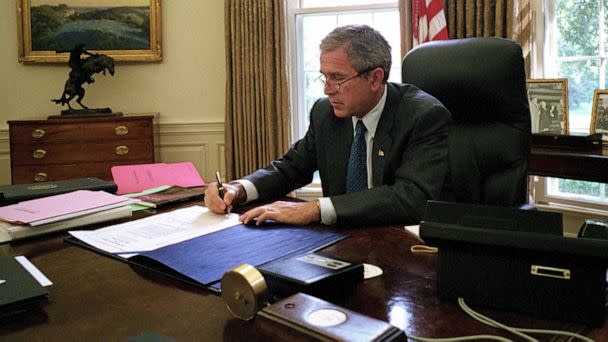 PHOTO: President George W. Bush signs a document that makes additional assistance available to the state of New York following the attacks on the World Trade Center in the White House in Washington, Sept. 18, 2001. (Tina Hager/AFP via Getty Images, FILE)