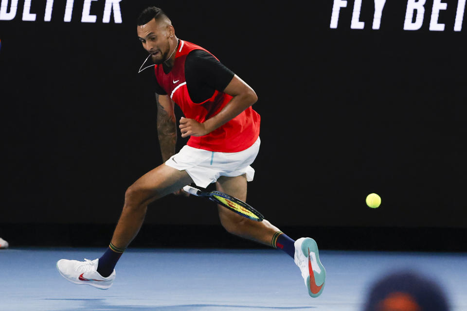 Nick Kyrgios of Australia plays a shot back between his legs during his second round match against Daniil Medvedev of Russia at the Australian Open tennis championships in Melbourne, Australia, Thursday, Jan. 20, 2022. (AP Photo/Hamish Blair)