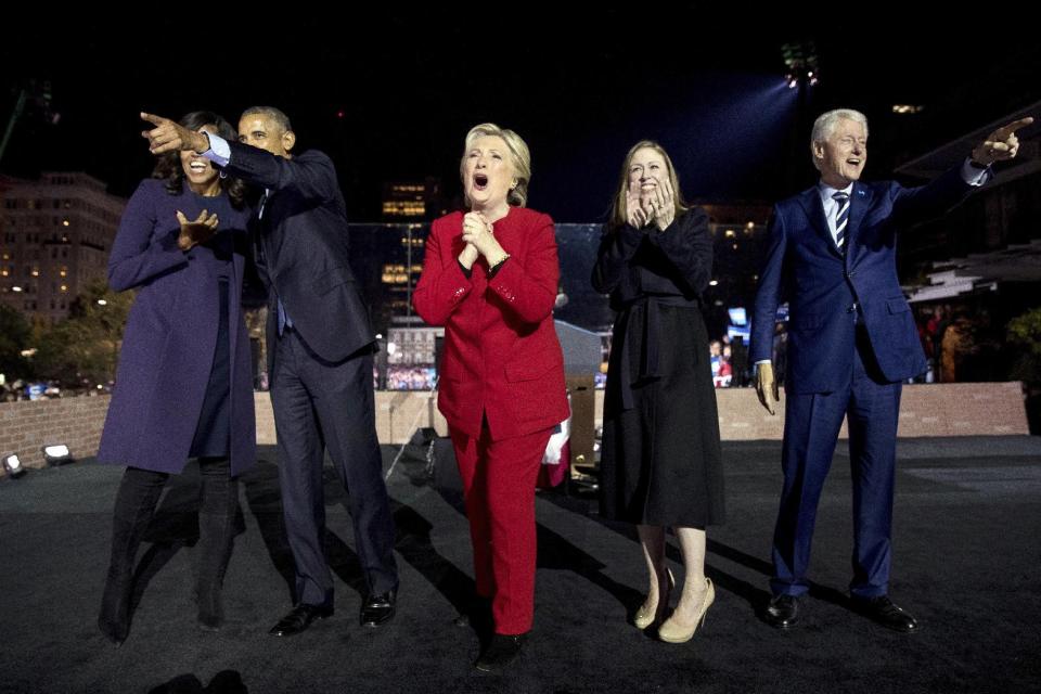 FILE - In this Monday, Nov. 7, 2016, file photo, Democratic presidential candidate Hillary Clinton, center, is joined onstage by first lady Michelle Obama, left, President Barack Obama, second from left, Chelsea Clinton, second from right, and former President Bill Clinton, right, after speaking at a rally at Independence Mall in Philadelphia. The former secretary of state, senator and first lady is working on a collection of personal essays that will touch upon the 2016 presidential campaign, Simon & Schuster told The Associated Press on Wednesday, Feb. 1, 2017. The book, currently untitled, is scheduled for this fall and will be inspired by favorite quotations she has drawn upon. (AP Photo/Andrew Harnik, File)