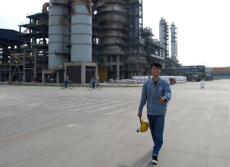 Employee Zheng Ruifeng walks at the factory area of Chambroad Petrochemicals in Boxing, Shandong Province, China, May 10, 2016. REUTERS/Meng Meng