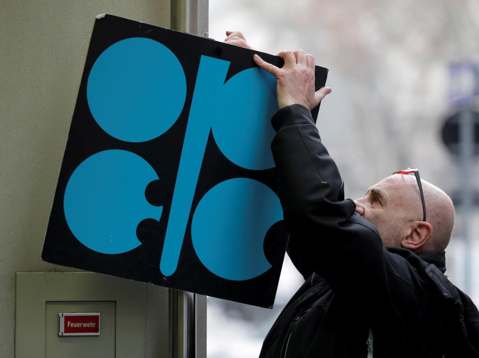 A man fixes a sign with OPEC’s logo next to its headquarters’ entrance before a meeting of OPEC oil ministers in Vienna, Austria, November 29, 2017. OPEC leaders will meet this week in Vienna to discuss the energy cartel’s policy. REUTERS/Heinz-Peter Bader