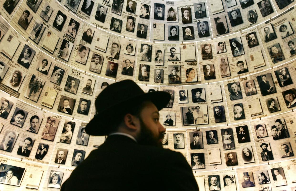 An Orthodox Jewish man looks at photographs of Jews murdered during the Holocaust at the Yad Vashem Holocaust Museum in Israel. <a href="https://media.gettyimages.com/id/52756974/photo/israel-marks-annual-holocaust-remembrance-day.jpg?s=1024x1024&w=gi&k=20&c=799KXl5lt_xItHaZzs3EURBgdH6qYoyRYPDesNF3A_c=" rel="nofollow noopener" target="_blank" data-ylk="slk:David Silverman/Getty Images;elm:context_link;itc:0;sec:content-canvas" class="link ">David Silverman/Getty Images </a>