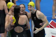The team from Australia celebrates after winning the final of the women's 4x100m freestyle relay at the 2020 Summer Olympics, Sunday, July 25, 2021, in Tokyo, Japan. (AP Photo/Petr David Josek)
