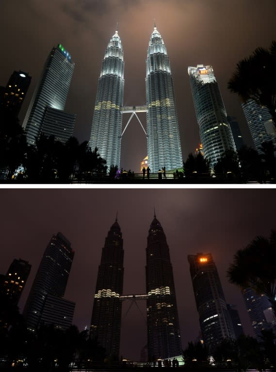 This combination of pictures created on March 19, 2016 shows the Petronas towers before (top) and after the lights were switched off (bottom) during the Earth Hour campaign in Kuala Lumpur on March 19, 2016