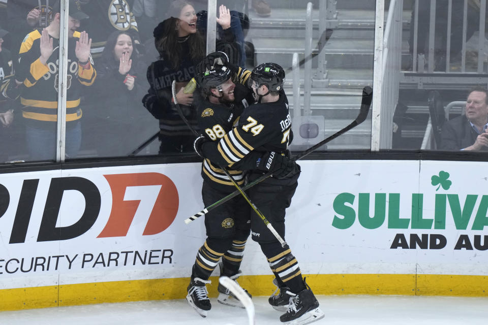 Boston Bruins right wing David Pastrnak (88) celebrates after his goal with left wing Jake DeBrusk (74) in the third period of an NHL hockey game against the Colorado Avalanche, Thursday, Jan. 18, 2024, in Boston. (AP Photo/Steven Senne)