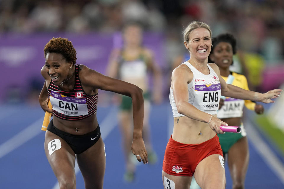 Team Canada's Kyra Constantine, left, and Team England's Jessie Knight cross the finish line of the Women's 4 x 400 meters relay during the athletics competition in the Alexander Stadium at the Commonwealth Games in Birmingham, England, Sunday, Aug. 7, 2022. England crossed ahead but was later disqualified and Canada took the gold medal. (AP Photo/Manish Swarup)