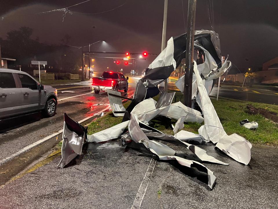 Metal believed to be from the sanctuary roof of St. Andrews Baptist Church is wrapped around a utility pole at the corner of Beck Avenue and U.S. 98 in Panama City Friday evening after a possible tornado roared through the area.