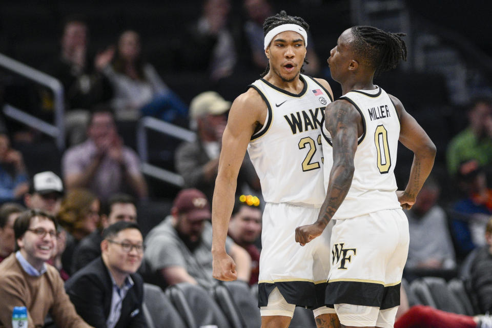 Wake Forest guards Hunter Sallis, left, and Kevin Miller celebrate after a play during the first half of an NCAA college basketball game against Notre Dame in the second round of the Atlantic Coast Conference tournament, Wednesday, March 13, 2024, in Washington. (AP Photo/Nick Wass)