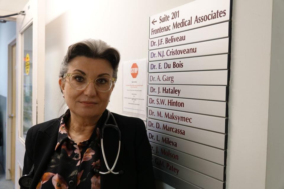 Dr. Lili Mileva stands next to the current lists of doctors at Frontenac Medical Associates. By the end of May the number of physicians practicing there will be down to two.