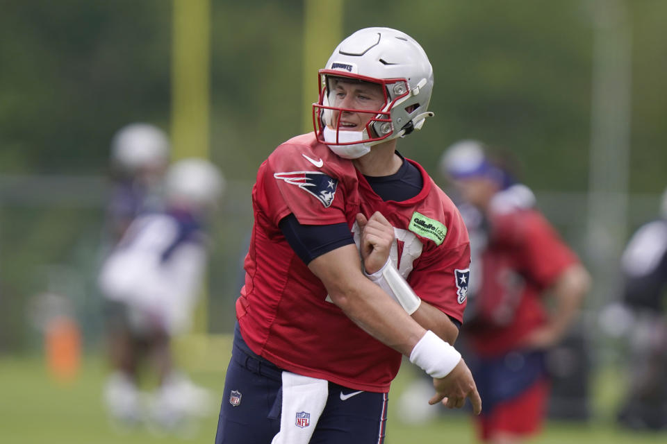 New England Patriots quarterback Mac Jones follows through on a pass during an NFL football practice, Tuesday, June 13, 2023, in Foxborough, Mass. (AP Photo/Steven Senne)