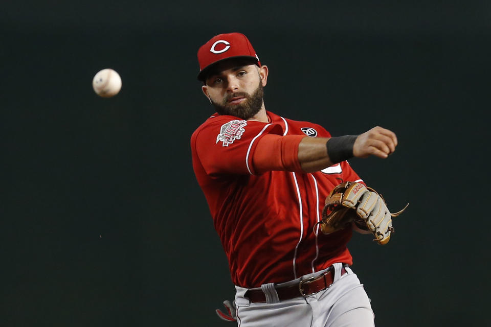 FILE - In this Sept. 15, 2019, file photo, Cincinnati Reds infielder José Peraza (9) throws the ball in the first inning during a baseball game against the Arizona Diamondbacks in Phoenix. People familiar with the negotiations tell The Associated Press on Friday, Dec. 13, 2019, that the Boston Red Sox have agreed to one-year contracts with free agent left-hander Martin Pérez and shortstop José Peraza. The people spoke on the condition of anonymity because the deals had not yet been announced. (AP Photo/Rick Scuteri, File)