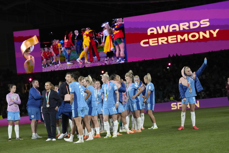 England's team look on Spain's team after the Women's World Cup final soccer match between Spain and England at Stadium Australia in Sydney, Australia, Sunday, Aug. 20, 2023. (AP Photo/Alessandra Tarantino)