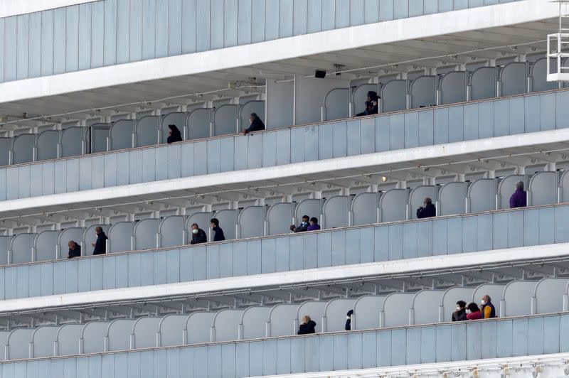 Passengers look out from the cruise ship Diamond Princess at Daikoku Pier Cruise Terminal in Yokohama, south of Tokyo