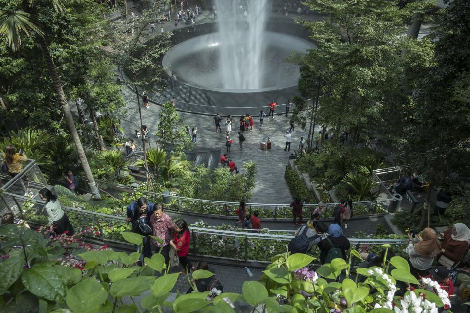 Visitors tour around the HSBC Rain Vortex, the worlds tallest indoor waterfall, at Jewel Changi Airport 