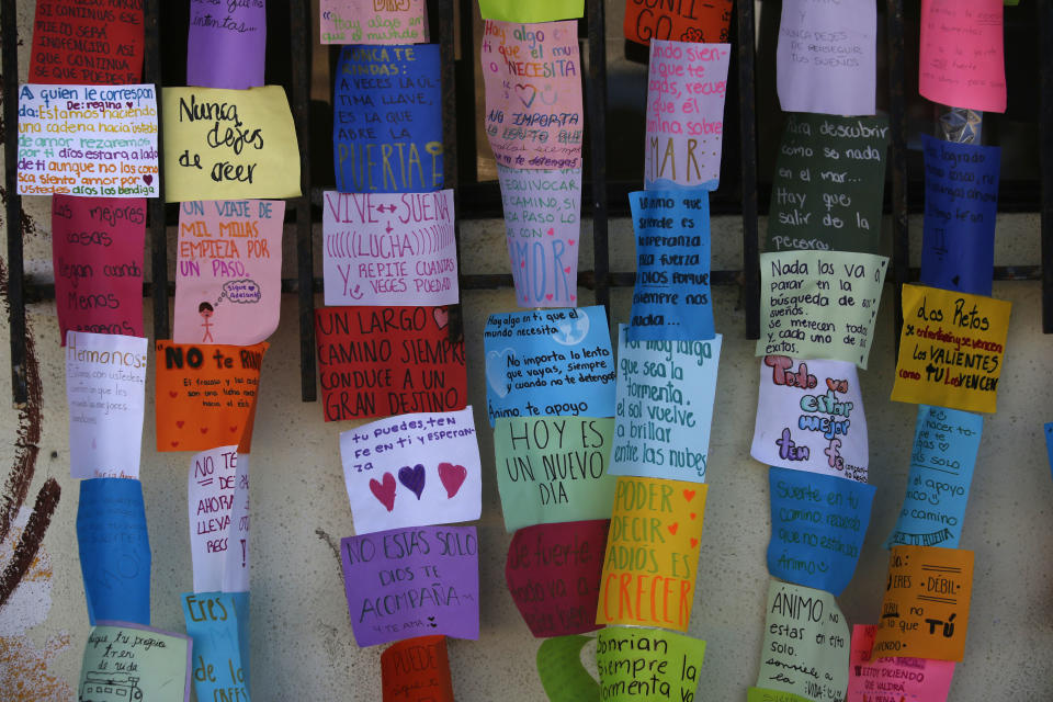 Inspirational messages written by asylum seekers are posted in the main entrance of a former concert venue known as El Barretal, now serving as a makeshift shelter for Central American migrants seeking asylum in the U.S., in Tijuana, Mexico, on Thursday, Dec. 13, 2018. (AP Photo/Moises Castillo)