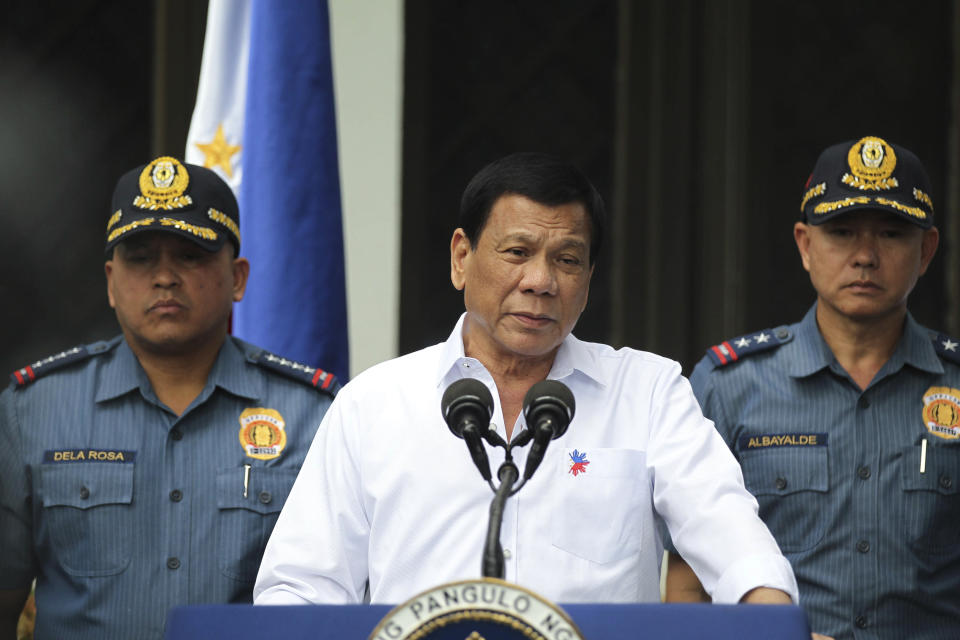 In this photo provided by the Presidential Photographers Division, Malacanang Palace, Philippine President Rodrigo Duterte, center, speaks to erring policemen during an audience at the Presidential Palace grounds in Manila, Philippines, Tuesday, Feb. 9, 2017. Duterte angrily berated more than 200 allegedly erring policemen and said he would send them to a southern island to fight extremists dreaded for their beheadings. Duterte's expletive-filled outburst against the officers at the palace was his latest tirade against a police force that he has called "rotten to the core." He recently banned the national police from carrying out his anti-drug campaign after a group of officers used the crackdown as a cover to kidnap and kill a South Korean man in an extortion scandal. (Simeon Celi Jr./Presidential Photographers Division, Malacanang Palace via AP)