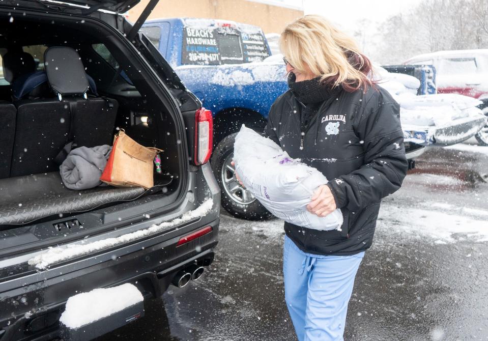 Pat Holden, from Croydon, gets a bag of rock salt from Beach’s Hardware as snow contines to fall in Bristol on Friday, Jan. 19, 2024.

Daniella Heminghaus | Bucks County Courier Times