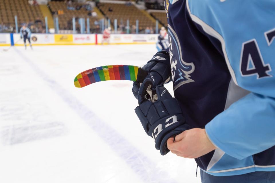 Rainbow-patterned tape covers the blade of Milwaukee Admirals left wing Navrin Mutter's stick as he takes to the ice for the pregame skate Tuesday during Pride Night at the UW-Milwaukee Panther Arena.