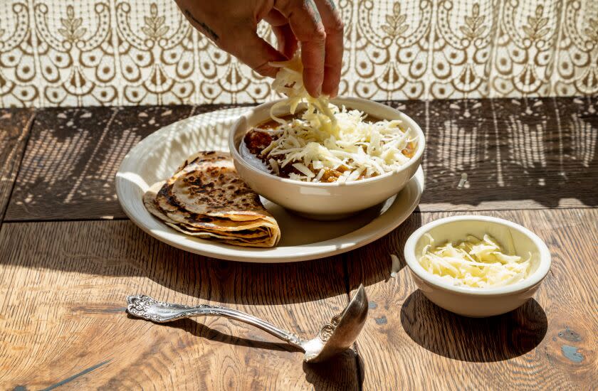 LOS ANGELES, CA - THURSDAY, MAY 4, 2023 - Chef/Owner Brian Dunsmoor putting graded cheese on top of his Green Chili Stew and Tortillas, at Dunsmoor restaurant on Eagle Rock Blvd., on May 4 2023, Los Angeles, (Photo by Ricardo DeAratanha)