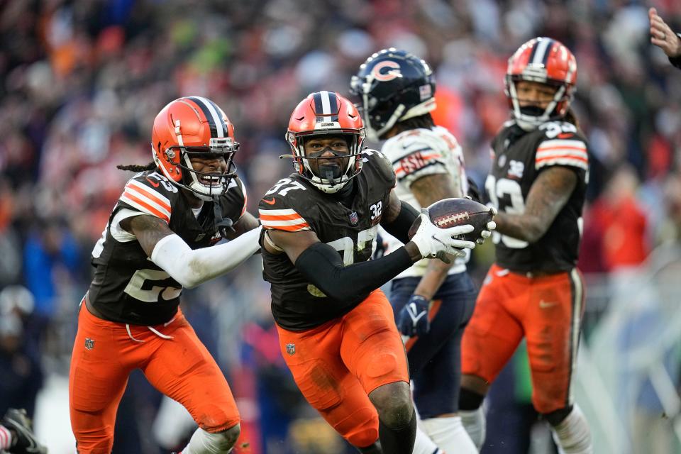 Cleveland Browns safety D'Anthony Bell (37) and Cleveland Browns cornerback Martin Emerson Jr. (23) celebrate in the second half against the Chicago Bears in Cleveland on Dec. 17.
