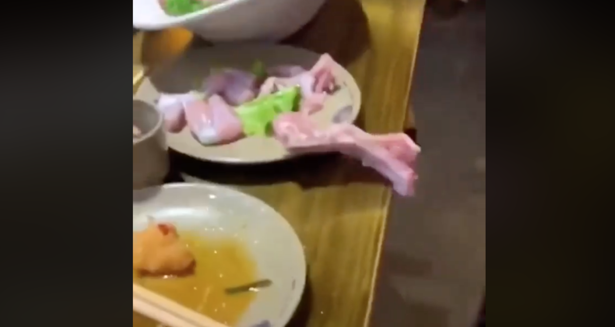 A raw piece of chicken seemingly crawls off a table at a restaurant. (Photo: Facebook)