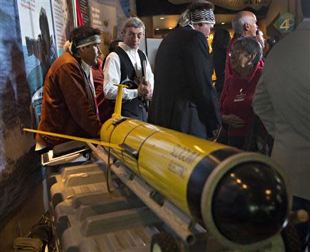 John Disney (2nd L), director of Old Massett Village economic development on Haida Gwaii, looks at the underwater probe used during their ocean fertilization project at a news conference in Vancouver, British Columbia, in this October 19, 2012 file picture. REUTERS/Andy Clark