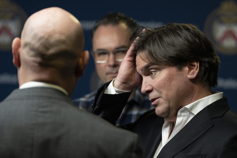Sean McCowan, right, reacts as he stands Kaelin McCowan, brothers of Erin Gilmour, after a press conference in Toronto, on Monday, Nov. 28, 2022. Toronto police say they've arrested a 61-year-old man in the DNA-linked cold-case murders of Gilmour and Susan Tice, who were found dead in their homes within months of each other almost four decades ago. (Chris Young/The Canadian Press via AP)