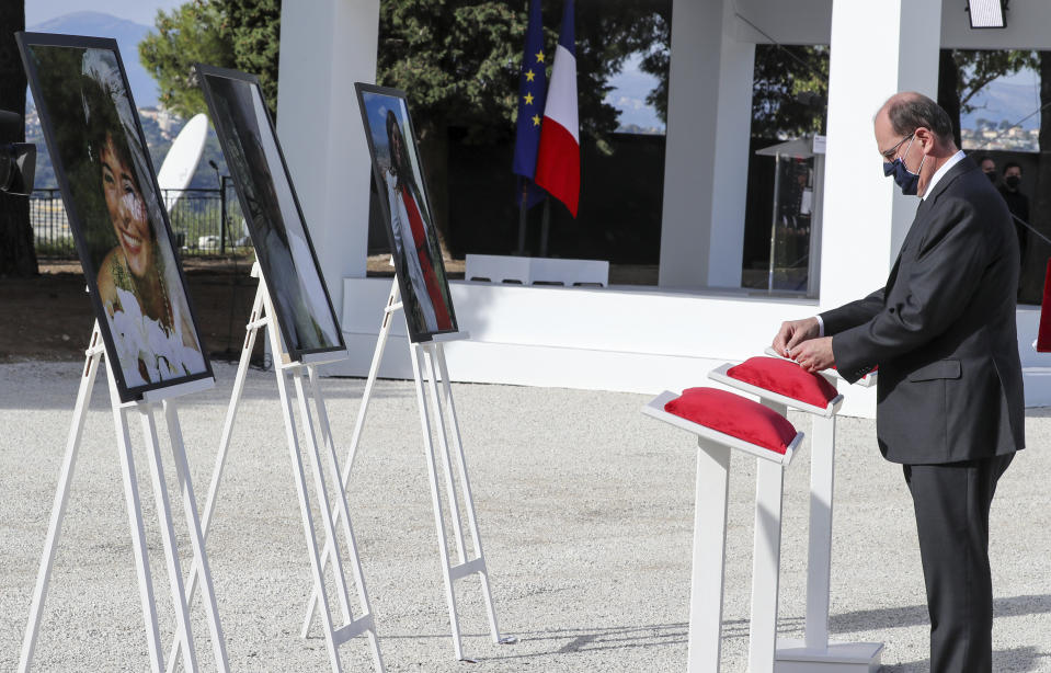 French Prime Minister Jean Castex awards posthumously the victims of a knife attack during a ceremony in Nice, southern France, Saturday Nov. 7, 2020. Three people were killed at Notre-Dame de Nice Basilica on Oct. 29, in an Islamic extremist attack at Notre Dame Basilica in the city of Nice that pushed the country into high security alert. (Valery Hache; Pool via AP)