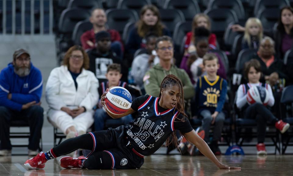 The Harlem Globetrotters' TNT Lister (18) shows off her fancy ball-handling skills against the Washington Generals during their game at Ford Center Monday, Jan. 16, 2023.