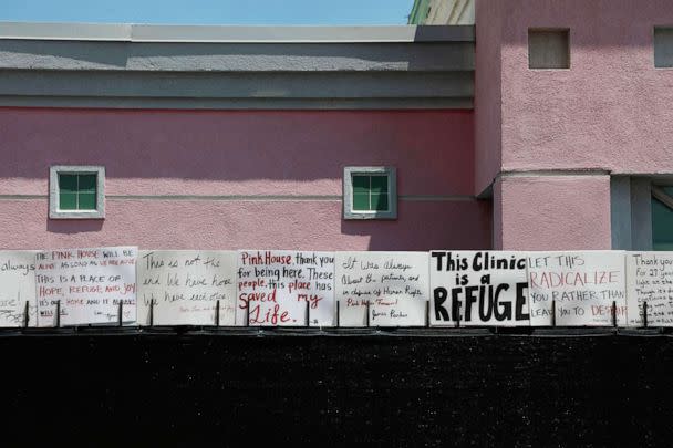 PHOTO: Signs by abortion rights activists sit on a fence outside of the Jackson Women's Health Organization in Jackson, Miss., July 7, 2022. The clinic performed it's last abortion July 7. (Sandy Huffaker/AFP via Getty Images)