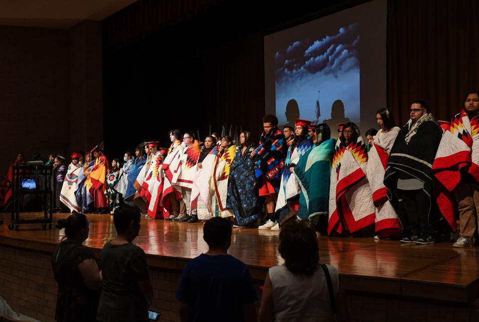 Native American students are wrapped in quilts as part of a celebration for their graduation from Sioux Falls public schools on Friday, May 27, 2022, at Washington High School.