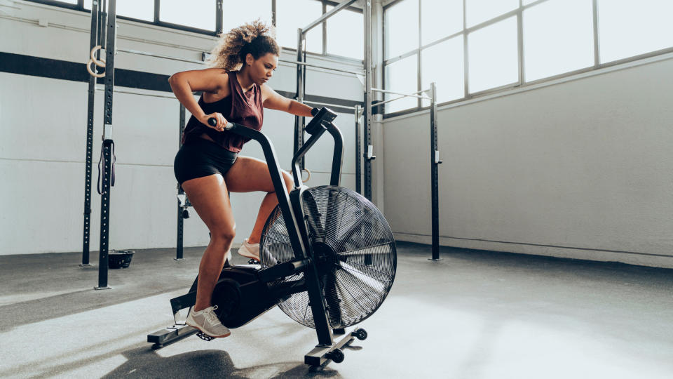 Woman using an air bike in a gym
