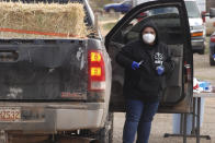 A medical worker administers the coronavirus vaccine at a drive-thru immunization clinic at a motor inn in Mora, N.M., on Tuesday, April 20, 2021. New Mexico is among the states with the highest rates of vaccination for COVID-19. Vaccine crews also traveled down dirt roads to visit homebound elderly residents in sprawling Mora County, with just 4,500 residents who are 80% Latino. First Lady Jill Biden was kicking off of a visit to the U.S. Southwest with a tour of a vaccination clinic in Albuquerque. (AP Photo/Morgan Lee)