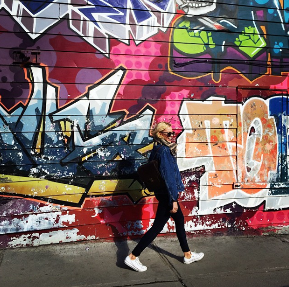 Margot Robbie poses with street art