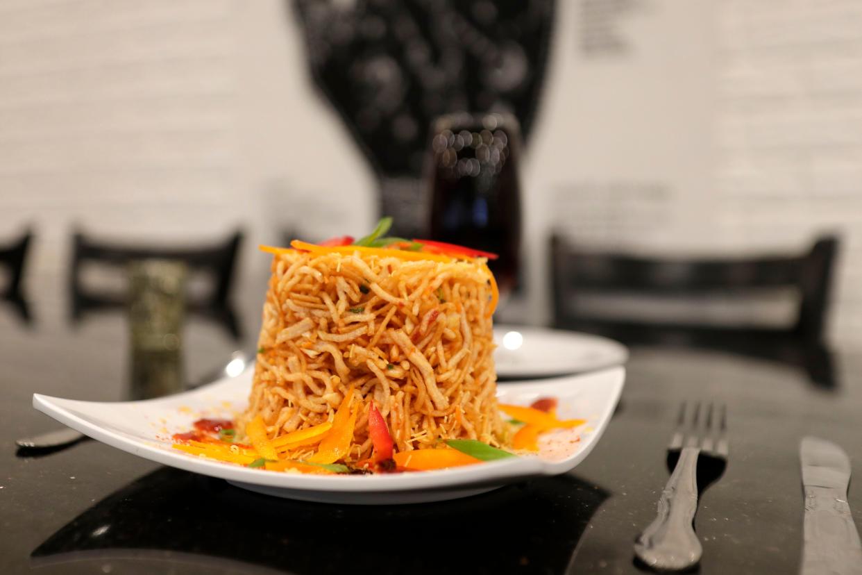 Chinese Bhel, a popular dish, a fast food item Northeast Indian origin, made of mixed fried noodles with shredded veggies and Aaru's special dressing. 