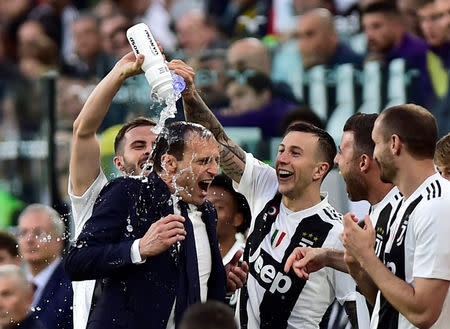 FILE PHOTO: Soccer Football - Serie A - Juventus v Fiorentina - Allianz Stadium, Turin, Italy - April 20, 2019 Juventus coach Massimiliano Allegri celebrates winning the league after the match with Federico Bernardeschi and team mates REUTERS/Massimo Pinca