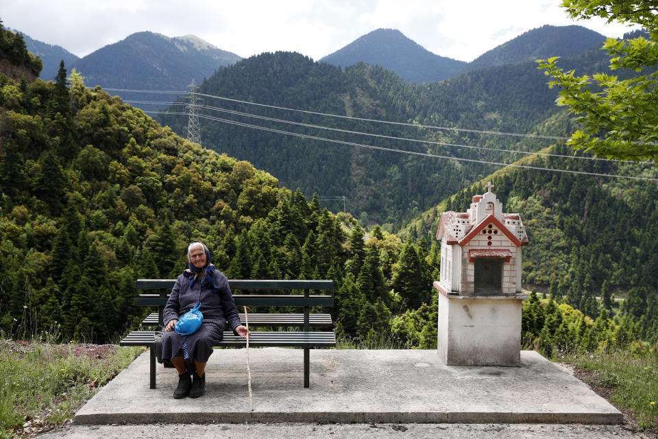 In this Wednesday, May 15, 2019, photo Alexandra Triantafyllopoulou, 91, sits on a bench in the village of Kalesmeno at Evrytania region, in central Greece. As balloting for the European Parliament gets underway Thursday and continues through Sunday voters over 55 are emerging as a powerful bloc on a rapidly aging continent as younger voters stay away from the polls in growing numbers. (AP Photo/Thanassis Stavrakis)