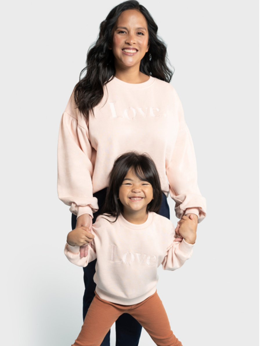 a mother and daughter wearing matching pink love sweater jumpers for mothers day 