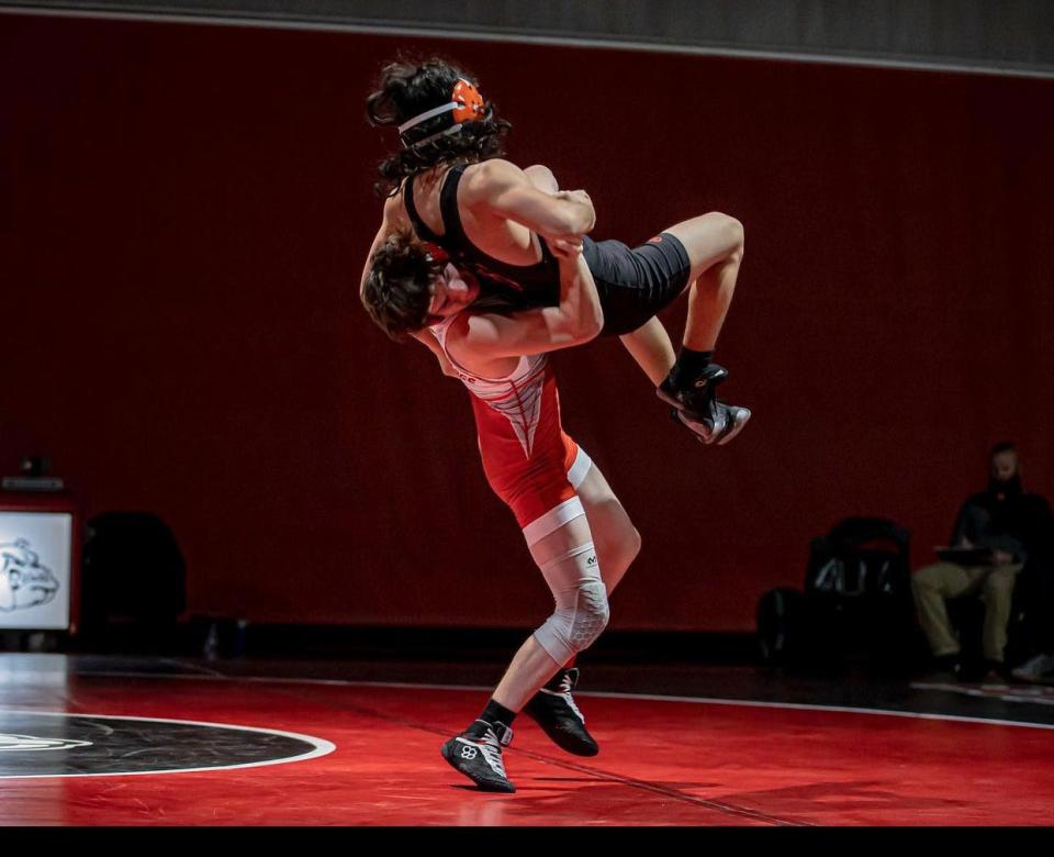 Oak Hills’ Noah Carr slams his opponent to the mat during the 126-pound match on Dec. 16, 2021.