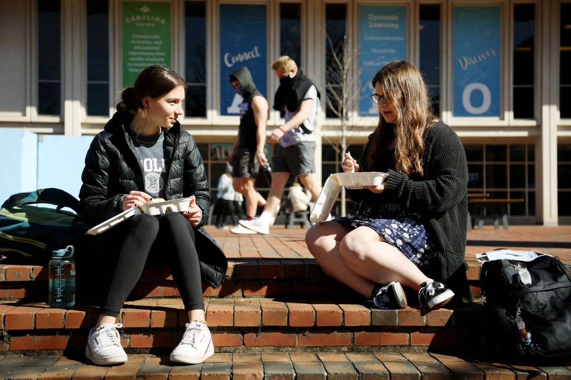 UNC Chapel Hill freshmen Eliza Jackson-Ald, left, and Julia Straight, right, have lunch together on campus Monday, Feb. 8, 2021, the same day the university began in-person classes.