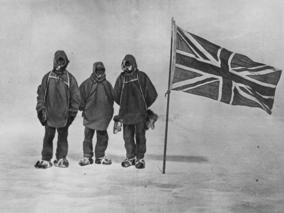 Sir Ernest Henry Shackleton and two members of his expedition team beside a Union Jack within 111 miles of the South Pole, a record feat (Getty)