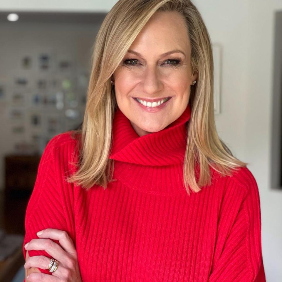 Melissa Doyle in a red jumper smiling at the camera