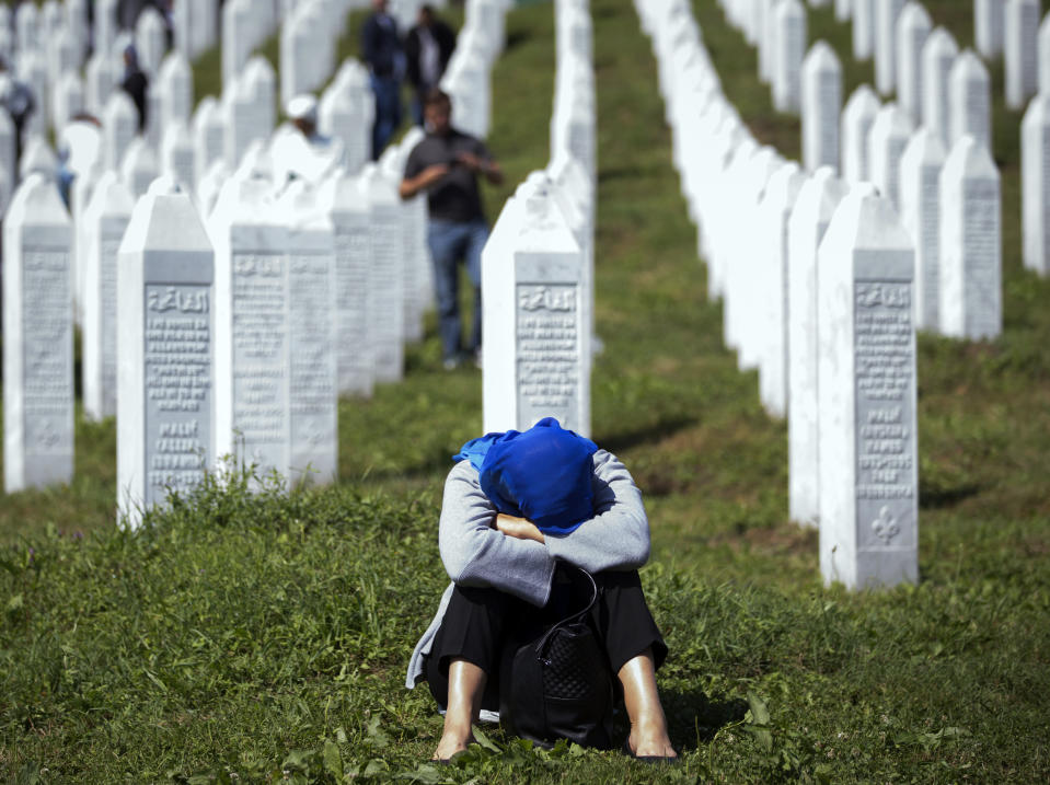A woman rests at the memorial cemetery, prior to the funeral in Potocari, near Srebrenica, Bosnia, Thursday, July 11, 2019. The remains of 33 victims of the Srebrenica massacre will be buried 24 years after Serb troops overran the eastern Bosnian Muslim enclave of Srebrenica and executed some 8,000 Muslim men and boys, which international courts have labeled as an act of genocide. (AP Photo/Darko Bandic)