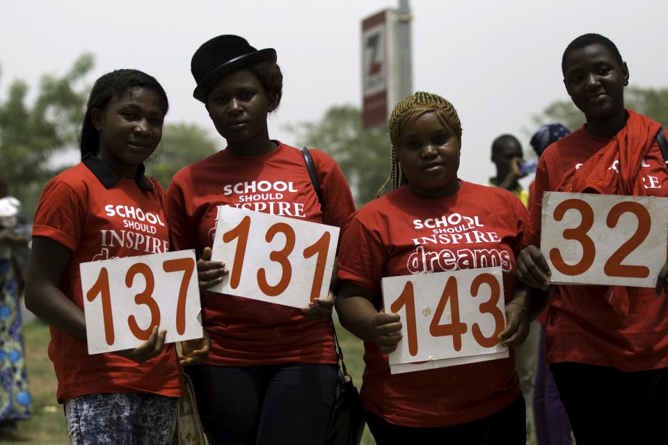 Students pose with placards as they join a march to mark the one-year anniversary of the mass kidnapping of more than 200 schoolgirls from a secondary school in Chibok by Boko Haram militants, in Abuja April 14, 2015. Nigeria's President-elect Muhammadu Buhari vowed on Tuesday to make every effort to free the schoolgirls abducted by Boko Haram militants a year ago but admitted it was not clear whether they would ever be found. (REUTERS/Afolabi Sotunde)