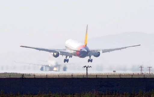 This file photo shows an Asiana Airlines landing at Incheon International Airport, west of Seoul, in 2011. South Korea will change some flight and navigation routes to keep planes and ships out of harm's way during North Korea's planned rocket launch next month, officials announced on Wednesday