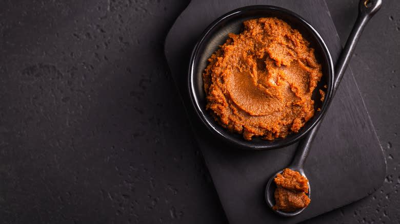 Red miso paste in black bowl