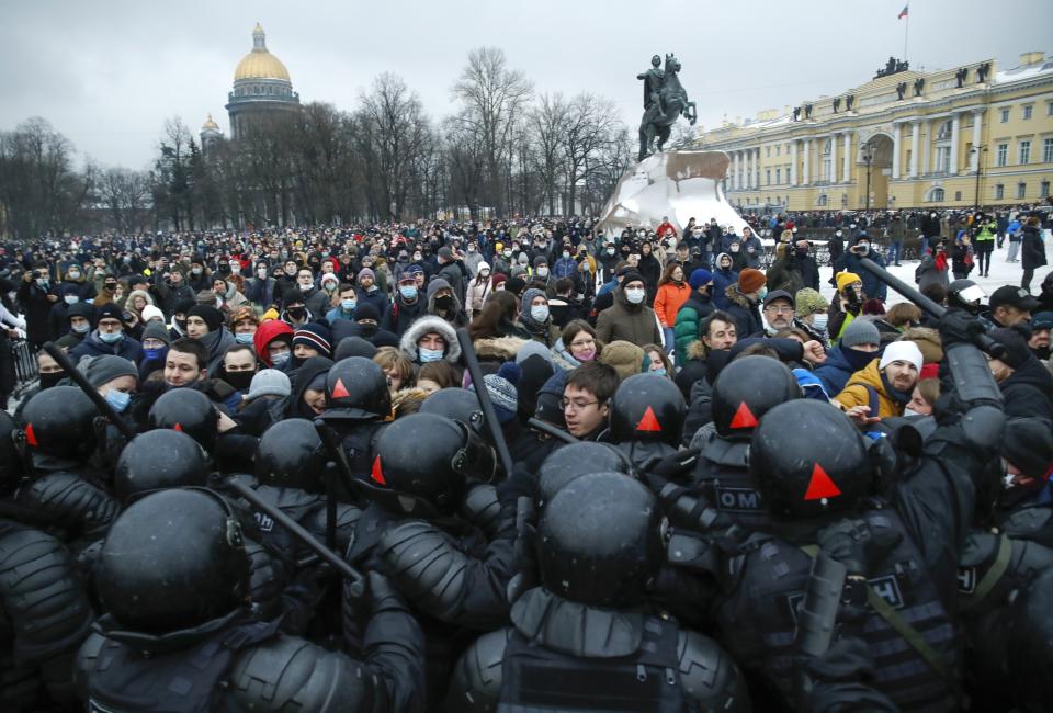 FILE - In this Jan. 23, 2021, file photo, protesters in St. Petersburg, Russia, clash with police over the jailing of opposition leader Alexei Navalny. Rattled by the nationwide demonstrations in support of the Kremlin foe, Russian authorities are moving rapidly to block any new ones – from piling legal pressure on his allies to launching a campaign to discredit the rallies. (AP Photo/Dmitri Lovetsky, File)