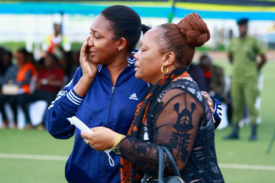 Mourners console each other at the Kaitaba Stadium in Bukoba (AFP via Getty Images)