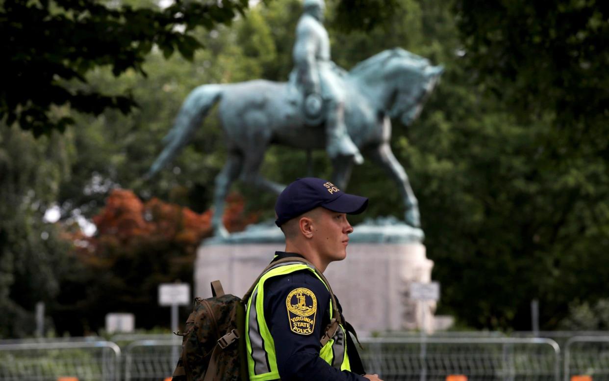 A policeman near the statue of Confederate Gen. Robert E. Lee in Charlottesville ahead of the anniversary of 2017's violent protests  - Getty Images North America