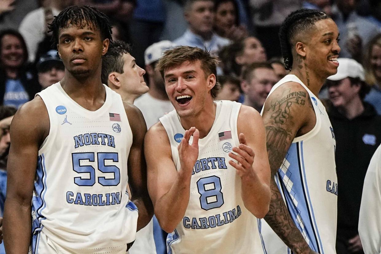 North Carolina players celebrate a win over Wagner during the second half of a first-round college basketball game in that NCAA Tournament, Thursday, March 21, 2024, in Charlotte, N.C. (AP Photo/Mike Stewart)